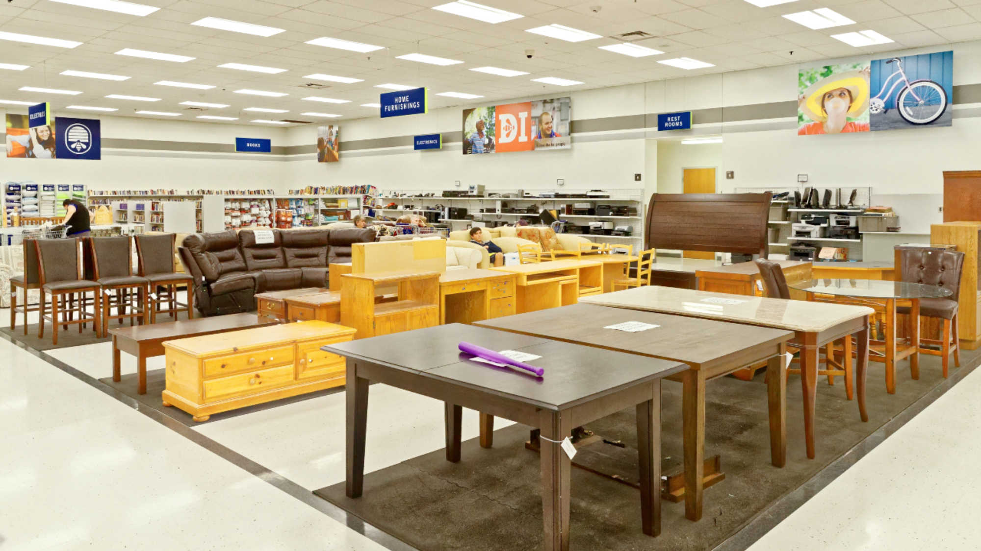 The furniture section at a Deseret Industries store, featuring a collection of secondhand tables, couches, and other items